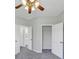 Bedroom with ceiling fan, a door to a closet, and a door to what looks to be an en-suite bathroom at 1685 Great Oaks Dr, Lawrenceville, GA 30045