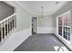 Bright dining room featuring a traditional chandelier, large window with natural light, and stairway access at 1685 Great Oaks Dr, Lawrenceville, GA 30045