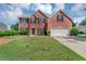 Charming two-story red brick home with black shutters and a well-maintained lawn at 1685 Great Oaks Dr, Lawrenceville, GA 30045