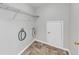 Simple laundry room with washer hookups, overhead shelving, and a utility closet at 1685 Great Oaks Dr, Lawrenceville, GA 30045