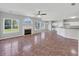 Open-concept living room featuring a fireplace, large windows, and seamless transition into the kitchen area at 1685 Great Oaks Dr, Lawrenceville, GA 30045