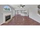 Open-concept living room featuring a fireplace, a ceiling fan and access to the kitchen and other rooms at 1685 Great Oaks Dr, Lawrenceville, GA 30045