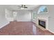 Bright living room features a fireplace, a ceiling fan and large format tile at 1685 Great Oaks Dr, Lawrenceville, GA 30045
