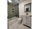 Updated bathroom features a shower, vanity, new fixtures, gray walls and white marble-look tile floors at 2127 Whites Mill Rd, Decatur, GA 30032