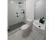 Modern bathroom featuring a glass shower with black hardware and a stylish black and white tiled floor at 2127 Whites Mill Rd, Decatur, GA 30032