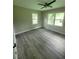 Bedroom with two windows, ceiling fan and vinyl floors at 2127 Whites Mill Rd, Decatur, GA 30032