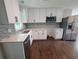 Bright kitchen features white cabinets, stainless steel appliances, quartz countertops, and a mosaic backsplash at 2127 Whites Mill Rd, Decatur, GA 30032