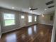 Open-concept living area with wood floors, recessed lights, fan, three windows and a white front door at 2127 Whites Mill Rd, Decatur, GA 30032