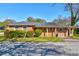 Charming brick home with a well-maintained lawn and neatly trimmed bushes enhancing its curb appeal at 5136 Jones Rd, Forest Park, GA 30297