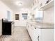 Classic kitchen features white cabinets, patterned floors, and ample counter space with updated appliances at 5136 Jones Rd, Forest Park, GA 30297