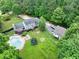 Aerial view of a home with a pool, deck, and a spacious yard surrounded by trees at 955 Chandler Haulk Rd, Loganville, GA 30052