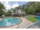 Spacious backyard with a pool, deck, and surrounding greenery at 955 Chandler Haulk Rd, Loganville, GA 30052