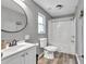 Neat bathroom with modern fixtures including a white vanity, toilet, and a shower/tub combination enclosed with a shower curtain at 955 Chandler Haulk Rd, Loganville, GA 30052