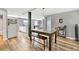 Open dining area with plank floors, stylish decor, a modern table with bench seating, and easy access to the kitchen and living room at 955 Chandler Haulk Rd, Loganville, GA 30052
