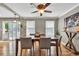 Dining room with an updated ceiling fan, hardwood floors, and neutral colored walls at 955 Chandler Haulk Rd, Loganville, GA 30052