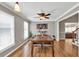Open-concept dining room featuring stylish hardwood floors and an elegant ceiling fan at 955 Chandler Haulk Rd, Loganville, GA 30052