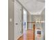 Hallway with wood floors, staircase, chandelier, and view into another room at 955 Chandler Haulk Rd, Loganville, GA 30052