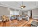 Open-concept living room with hardwood floors, comfortable seating, and access to staircase, perfect for entertaining at 955 Chandler Haulk Rd, Loganville, GA 30052