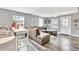 Inviting living space featuring an open floor plan and plank flooring, with a comfortable sectional couch, and kitchen bar at 955 Chandler Haulk Rd, Loganville, GA 30052