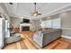 Beautiful living room featuring a fireplace, hardwood floors, tray ceiling, and a comfortable gray sectional at 955 Chandler Haulk Rd, Loganville, GA 30052