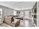 Comfortable living room with neutral tones, plank floors, a ceiling fan, and an entertainment center with wall-mounted TV at 955 Chandler Haulk Rd, Loganville, GA 30052