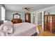 Bright primary bedroom with hardwood floors, neutral walls, traditional furniture, and ensuite bathroom access at 955 Chandler Haulk Rd, Loganville, GA 30052