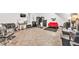 Large salon space with multiple styling chairs, mirrors, and a red sofa at 955 Chandler Haulk Rd, Loganville, GA 30052