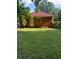 Backyard featuring a brick home with green grass and trees providing shade at 1275 Bell Ave, Atlanta, GA 30344