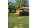 Lush backyard with trees and a quaint brick home adding a serene and private outdoor space at 1275 Bell Ave, Atlanta, GA 30344