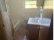 Modest bathroom featuring a tub/shower combo, tiled walls, and basic vanity with storage at 1275 Bell Ave, Atlanta, GA 30344