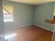 Bedroom with hardwood floors and a bright window, offering potential for renovation at 1275 Bell Ave, Atlanta, GA 30344