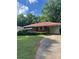 Traditional brick home with a red roof, cozy covered porch, and a well-kept lawn at 1275 Bell Ave, Atlanta, GA 30344