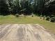 Expansive backyard offers plenty of room, featuring a swing set and lush trees at 2550 Kentshire Way, Lawrenceville, GA 30044