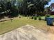A spacious backyard featuring a swing set and a serene view of lush, mature trees at 2550 Kentshire Way, Lawrenceville, GA 30044