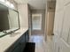 Bright bathroom featuring tiled floors, a modern vanity, and combined shower and tub at 2550 Kentshire Way, Lawrenceville, GA 30044