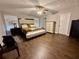 Spacious bedroom with hardwood floors, ceiling fan, and natural light from the window at 2550 Kentshire Way, Lawrenceville, GA 30044