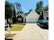 Charming single-story home with a well-manicured lawn, mature trees and a two-car garage at 2550 Kentshire Way, Lawrenceville, GA 30044