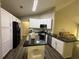 Modern kitchen with white cabinets, stainless steel appliances, and dark countertops at 2550 Kentshire Way, Lawrenceville, GA 30044