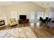 Living room featuring hardwood floors, a fireplace and an adjacent dining area at 2550 Kentshire Way, Lawrenceville, GA 30044