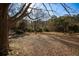 Extensive backyard space, perfect for recreation, with trees bordering the property at 272 Old Sudie Rd, Hiram, GA 30141