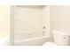 A full bathroom with an all white tiled shower and tub at 272 Old Sudie Rd, Hiram, GA 30141