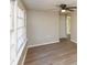 Bright room with lots of natural light from a large window, hardwood floors and neutral paint at 272 Old Sudie Rd, Hiram, GA 30141