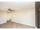 A light-filled empty room with hardwood floors and a ceiling fan viewed from the open front door at 272 Old Sudie Rd, Hiram, GA 30141