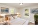 Cozy bedroom with plush bedding, two windows, and decorative wall art at 272 Old Sudie Rd, Hiram, GA 30141
