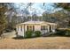 Ranch-style home with a well-kept lawn, mature trees, a ramp and classic white siding with black shutters at 272 Old Sudie Rd, Hiram, GA 30141