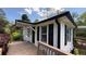 View of the home's exterior highlighting ramp access, a covered entry, and mature landscaping under a blue sky at 272 Old Sudie Rd, Hiram, GA 30141