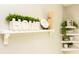 White shelves decorated with a houseplant and other homey decor items at 272 Old Sudie Rd, Hiram, GA 30141