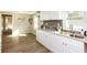 Well-lit kitchen with stainless steel sink, white cabinets, and a modern backsplash at 272 Old Sudie Rd, Hiram, GA 30141