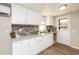 Modern kitchen featuring white cabinets, stone countertops, and stainless steel sink at 272 Old Sudie Rd, Hiram, GA 30141