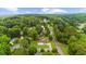 Aerial view of a charming home nestled amidst lush greenery with a long driveway at 4605 Tims Pl, Snellville, GA 30039